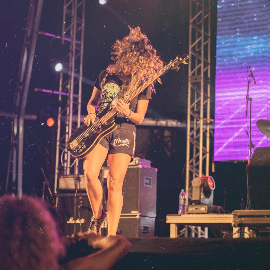 Person Playing Electric Guitar on Stage